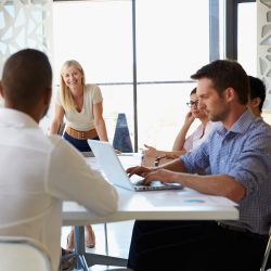 Businesswoman presenting to colleagues at a meeting Businesswoman presenting to colleagues at a meeting